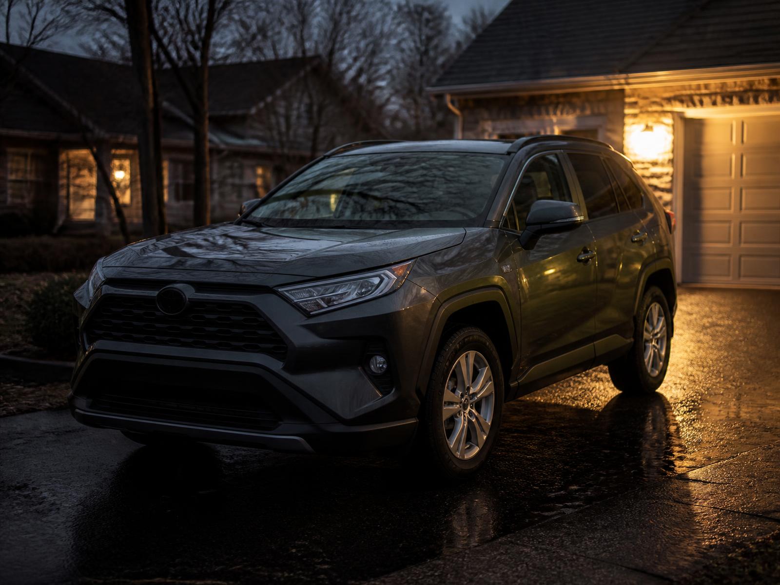 Charcoal grey compact SUV on a suburban driveway at dusk
